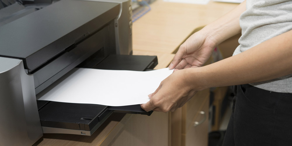 Photo: Printer with hands collecting printout